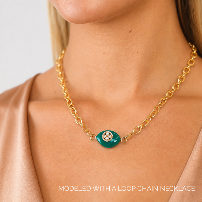 Blue Onyx Clover Charm showcased on a gold loop chain necklace against a neutral background.