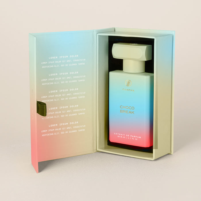 Front view of Choco Break perfume in open box showing blue-to-pink gradient bottle with white cap and shiny interior