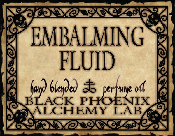 Label for 'Embalming Fluid' by Black Phoenix Alchemy Lab with decorative border and text.