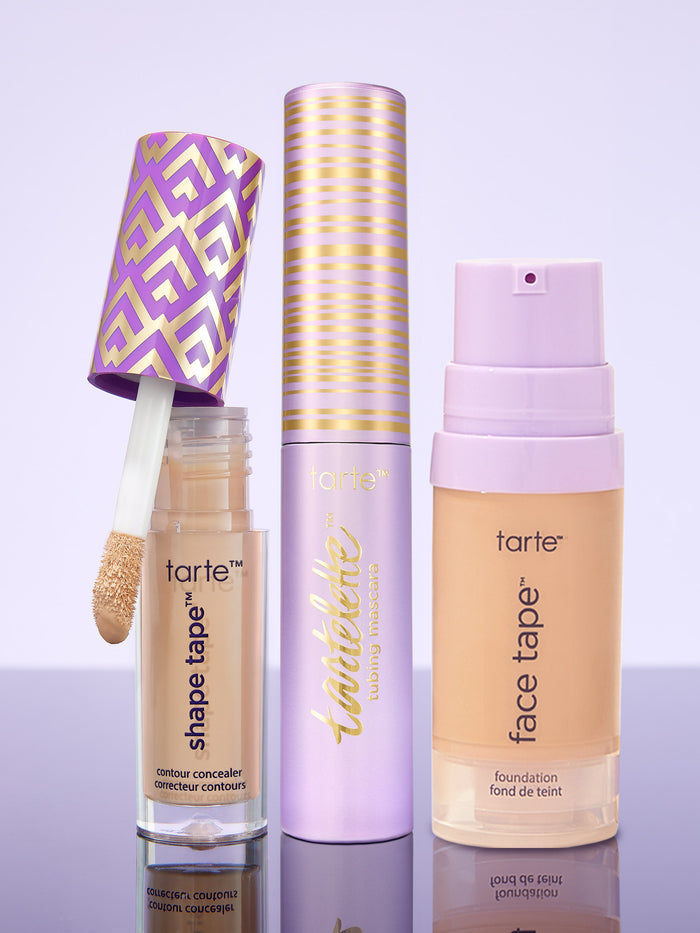 tarte shape tape concealer, tartelette tubing mascara, and tarte face tape foundation on a purple background