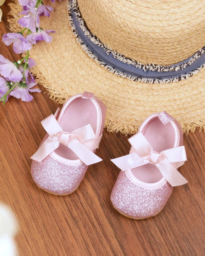 Pink sequin toddler sandals with white bow straps and Mary Jane design