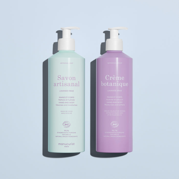 On a light blue background: two pump bottles by Manucurist, including the pale green "Artisan Soap" and the lavender "Organic Lavender Hand Body Wash - Cosmos Organic," both for hands and body.