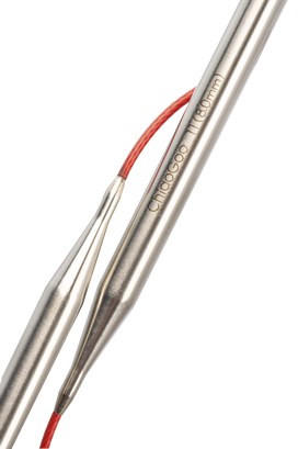 Close up of connection between stainless steel needles and red cables on circular knitting needles; Needles read "ChiaoGoo 11(8.0mm) in light bronze