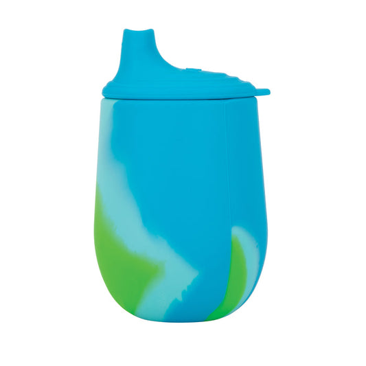 The Nuby US Baby's First All Silicone Sippy Cup is a blue training cup with a free-flow spout and green and white swirl patterns on the side, shown isolated on a white background.