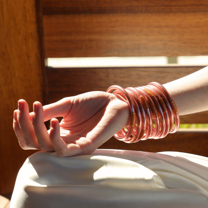 a hand with bracelets on wrist