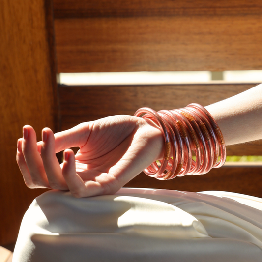a hand with bracelets on wrist