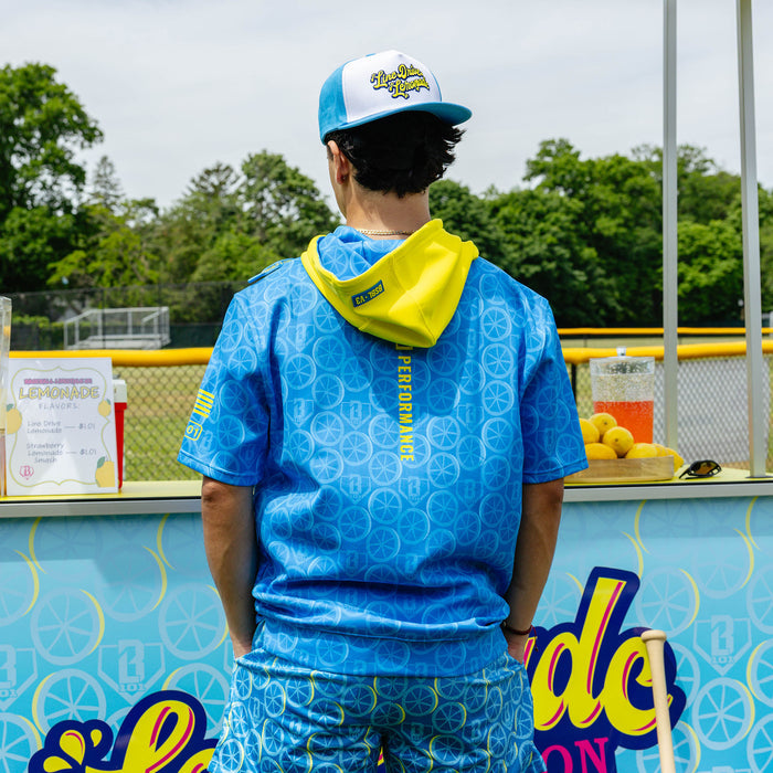 Adult model wearing blue short sleeve hoodie with "BSBL-SZN V3" design