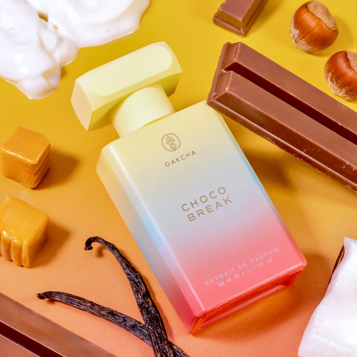 Front view of Choco Break bottle showing pink-to-cream ombre glass with chocolate and vanilla on warm yellow background