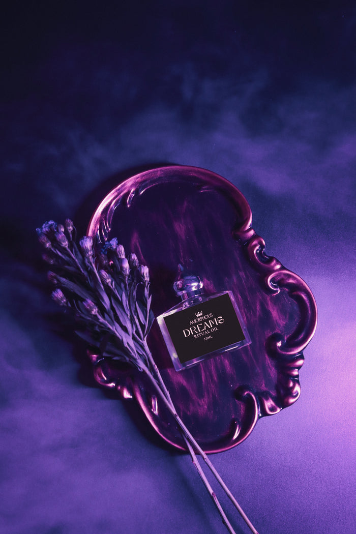dream spell ritual oil on a black background