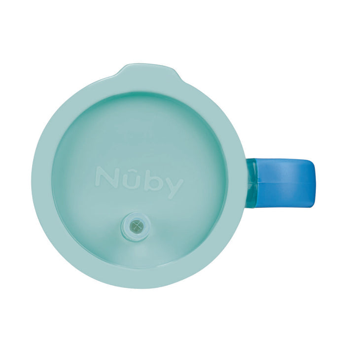 Top view of the Insulated Tiny Tumbler in Seafoam, featuring a circular design with a blue handle on the right side. The tumbler has a small spout in the center and the Nuby logo embossed on the lid.