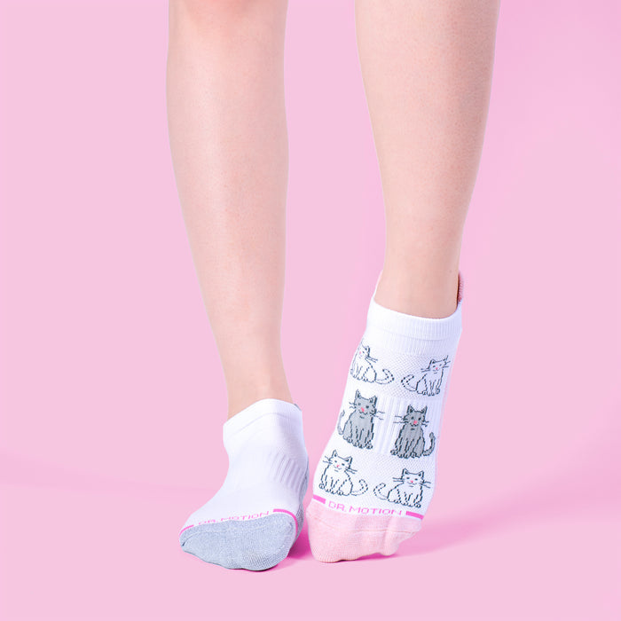 Ankle compression socks featuring a cat design, one sock in white and gray, the other in white and pink.