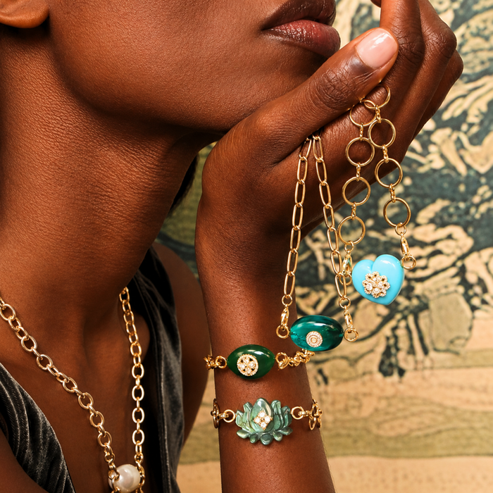 Laguna Stone Heart Charm and other elegant jewelry pieces showcased on a model's hand.