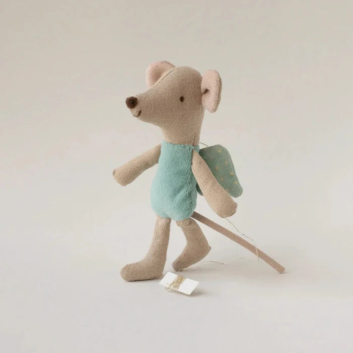 Stuffed toy mouse with a backpack on a plain background