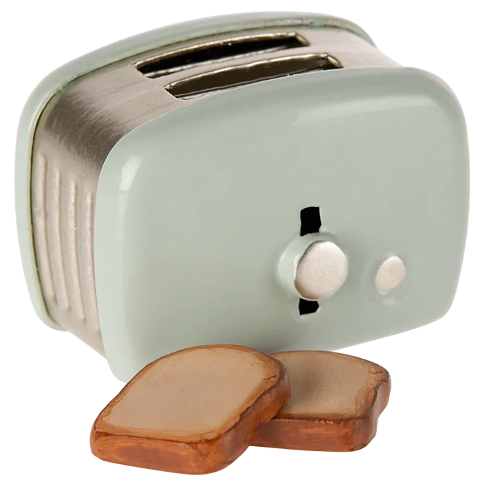 Small mint green toaster with two slices of bread on a white background