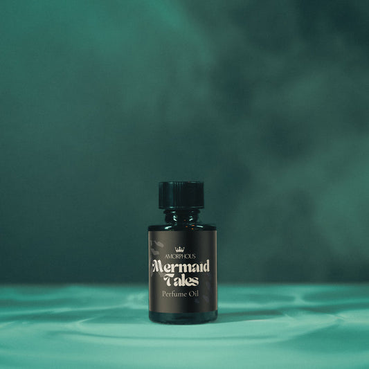 Bottle of 'Mermaid Tales' perfume oil on a green background
