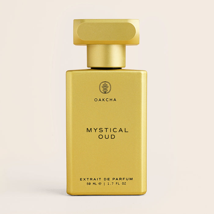 Front view of Mystical Oud 50 ml perfume bottle showcasing matte gold rectangular bottle and cap on a beige background