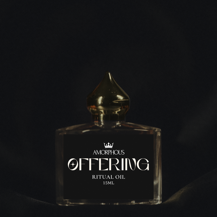 Amorphous Offering Ritual Oil bottle with gold cap on a dark background