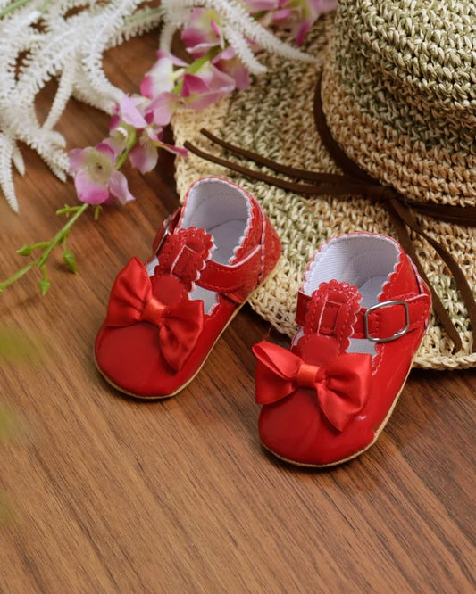 Red toddler sandals with bow detail and adjustable strap buckle