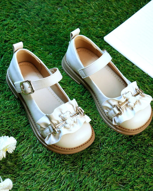White girls' sandals with buckled strap and floral bow embellishments