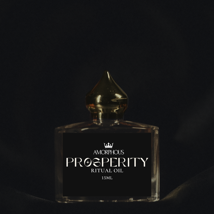 Amorphous Prosperity Ritual Oil bottle on a dark background
