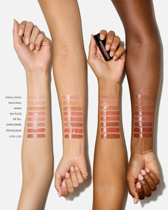 Three arms with Squeaky Lip Balm swatches on a white background