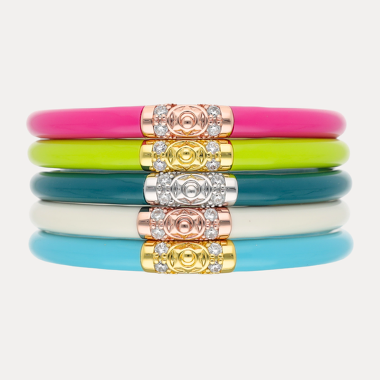 The Nantucket Luxe Stack featuring colorful bangles in pink, green, white, and blue with decorative embellishments.