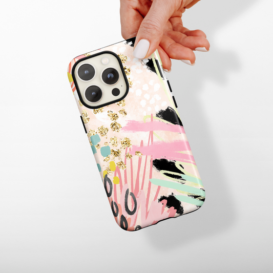 Hand holding phone with Coconut Lane Tough Phone Case in pink, gold, black, and mint green abstract pattern.