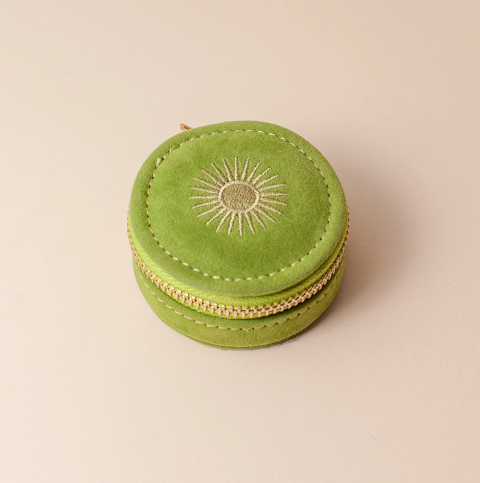 cai and jo Green round jewelry box with sun design on a beige background