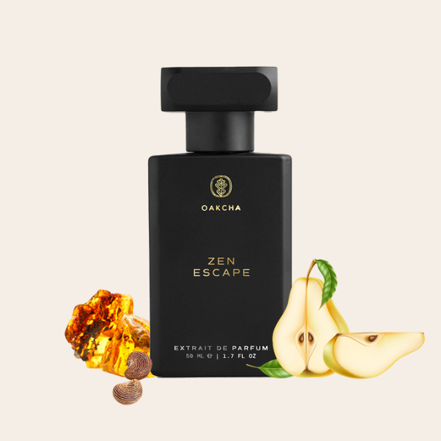 Front view of Zen Escape extrait de parfum showcasing matte black bottle with gold logo, pear slices and amber on pale beige